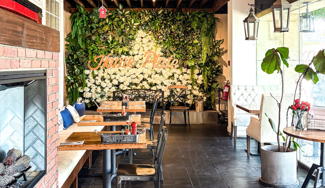 Interior dining room at Home Plate with fireplace, living plant wall, and pendant lighting, Lombard Street, Marina District, San Francisco CA