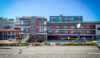 Street-level view of La Luna Inn in San Francisco's Marina District, showing the multi-story motel exterior with red accents and the property sign visible on the right.
