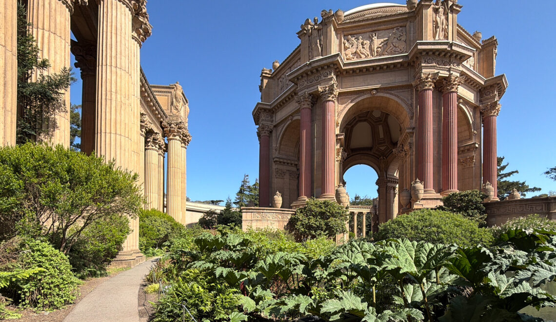 The rotunda of the Palace of Fine Arts framed by colonnades and lush garden greenery, San Francisco, California